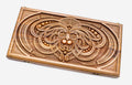 Master-carved walnut backgammon board with a symmetrical knotwork mask, propped open