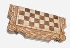 Close-up of the carved crown and ribbon banner on the board border