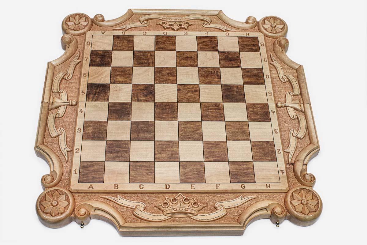 Angled view of the royal carved chess set with its wooden and bronze-crowned pieces
