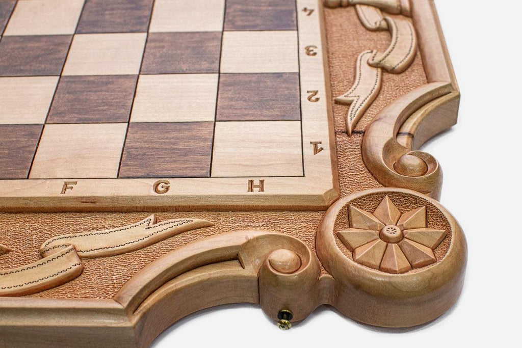 Close-up of the carved floral rosette and scrollwork corner of the board