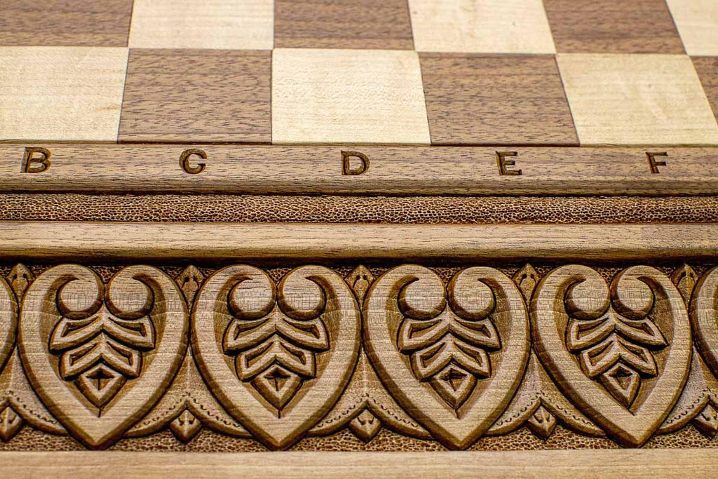 Close-up of master-carved royal detailing carving on the walnut board