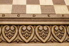 Close-up of master-carved royal detailing carving on the walnut board