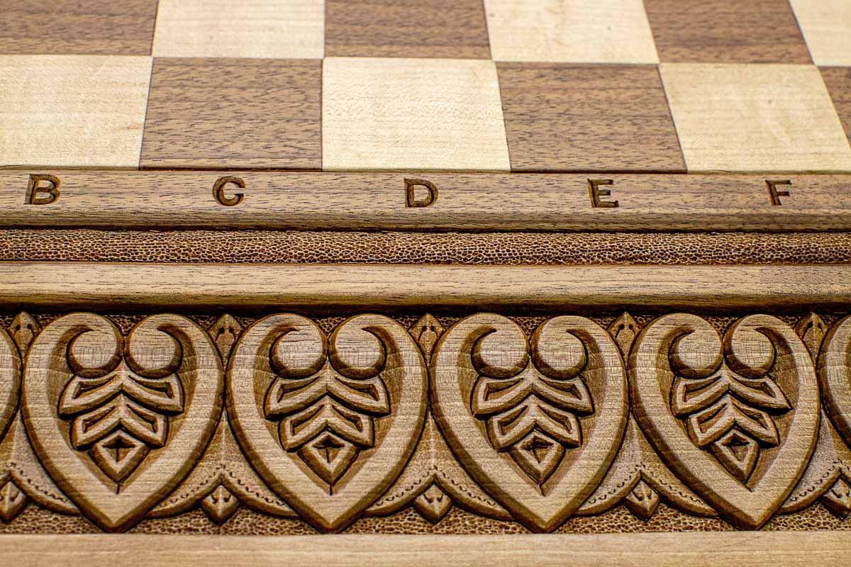 Close-up of master-carved royal detailing carving on the walnut board