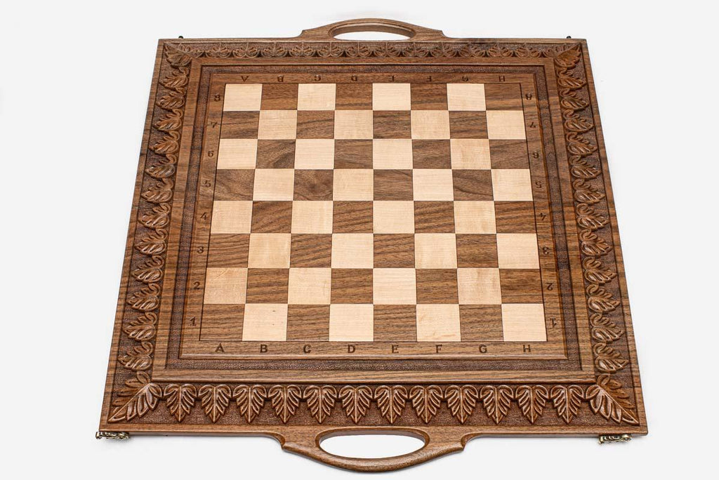 Close-up of master-carved ornate detailing carving on the walnut board