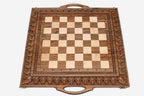 Close-up of master-carved ornate detailing carving on the walnut board