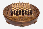 Angled view of the round carved chess set with dark and light Staunton pieces arranged on the board