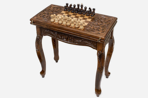 Handle Scrollwork chess and backgammon table set up for chess, angled view showing the carved legs