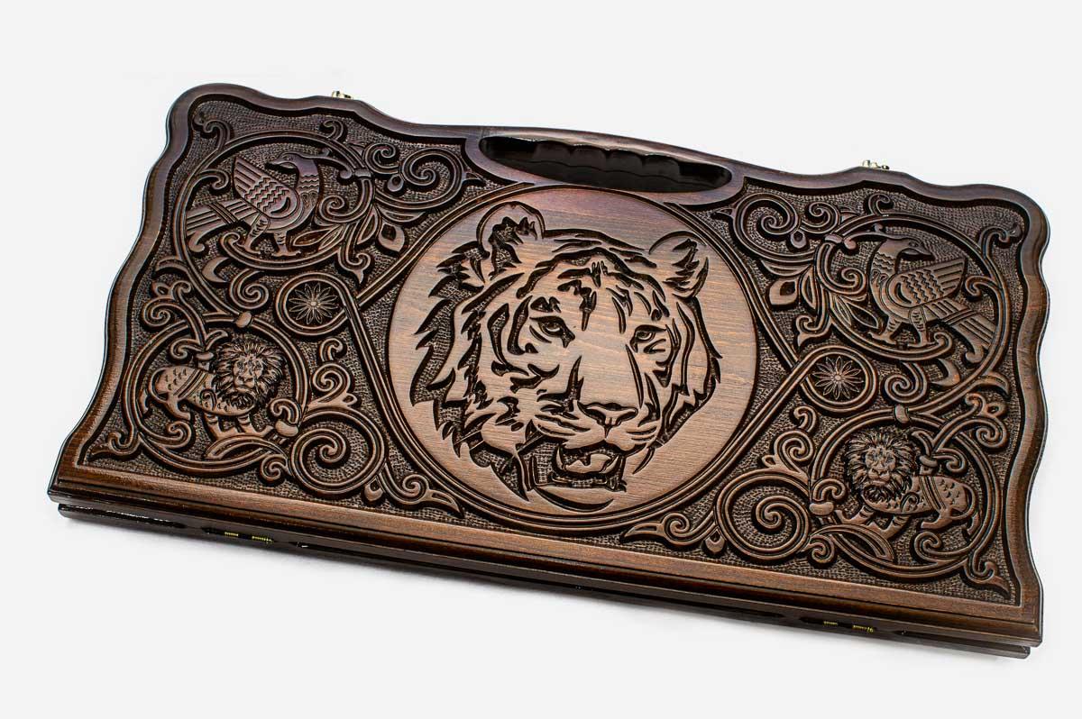 Carved beechwood backgammon board with a tiger medallion and a carry handle, propped open