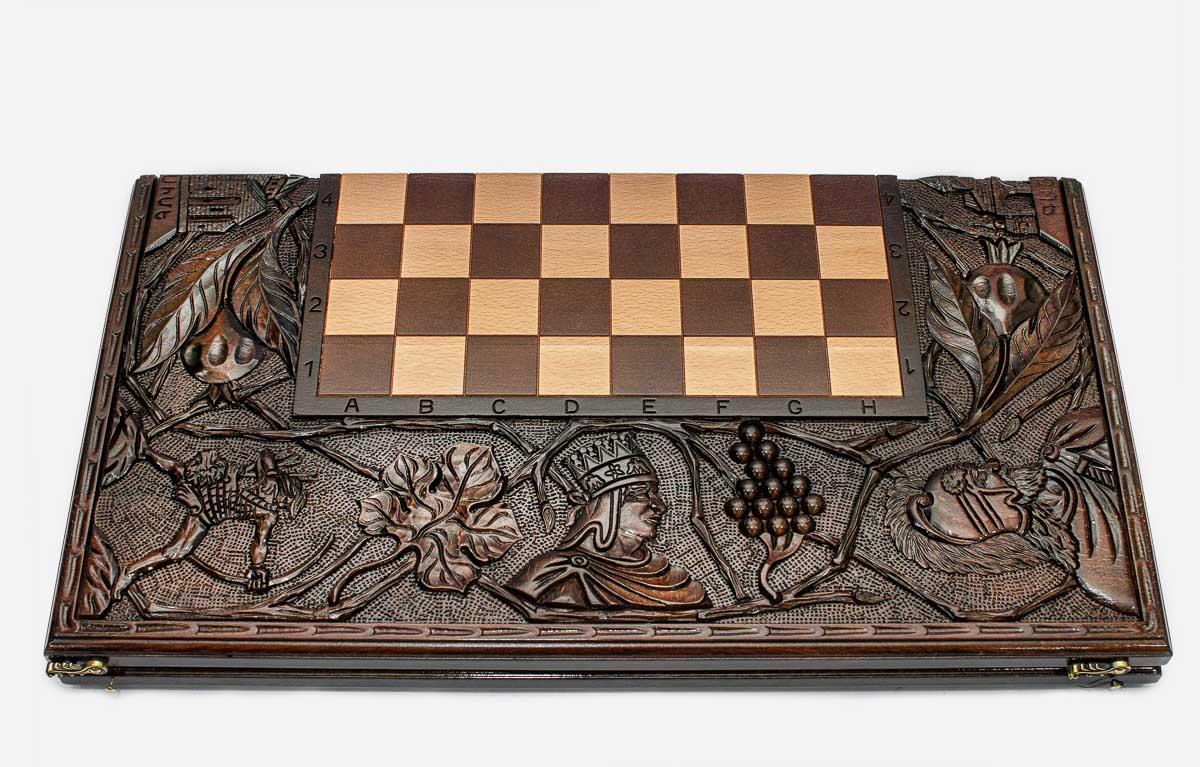Close-up of crowned kings carving on the beech board