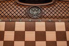Close-up of the faceted wooden chess pieces on the inlaid squares