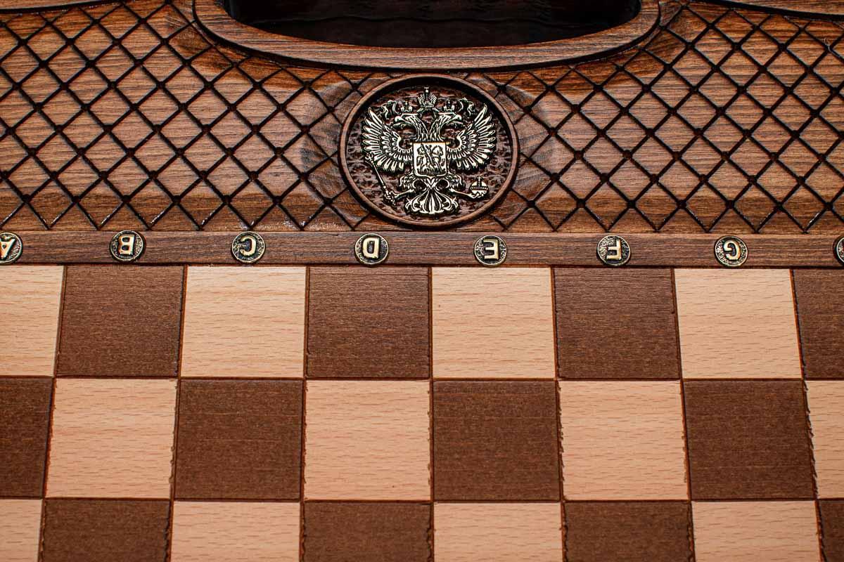 Close-up of the faceted wooden chess pieces on the inlaid squares