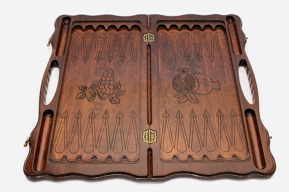 Close-up of the pomegranate and grapevine carving on the walnut board