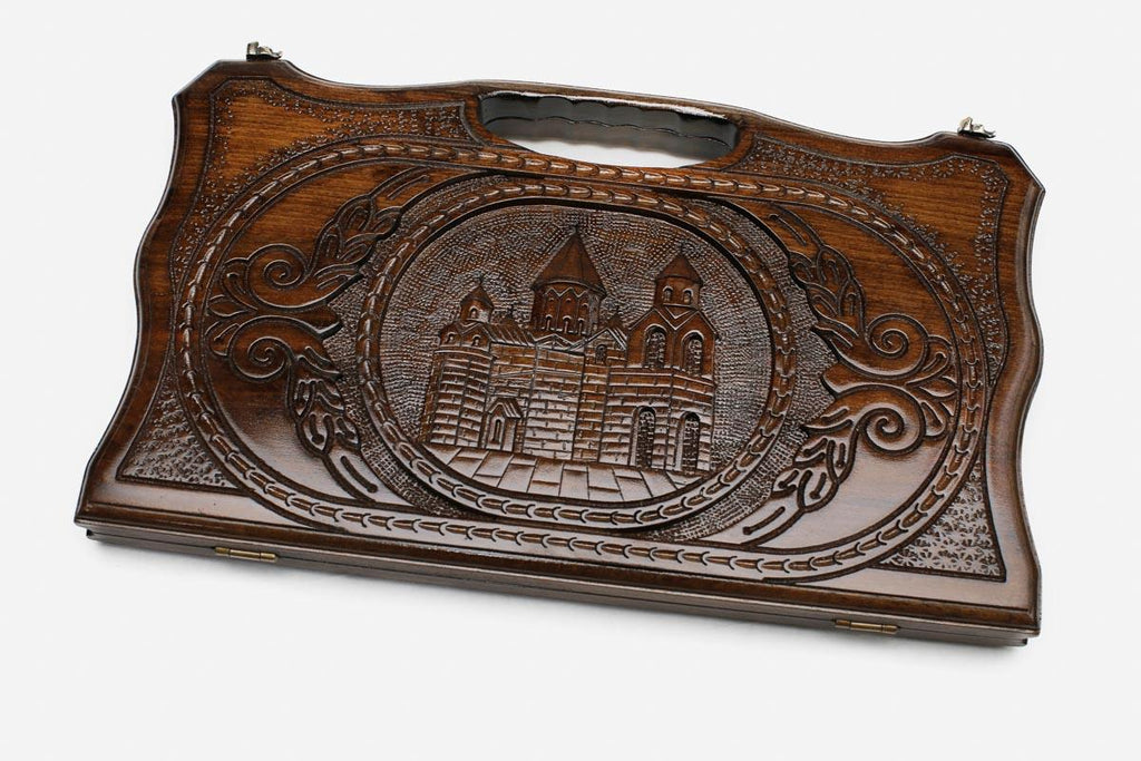 Compact carved beechwood backgammon board with Echmiadzin Cathedral and a carry handle, propped open