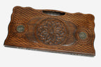 Carved beechwood backgammon board with a central rosette mandala and bronze roundels, propped open