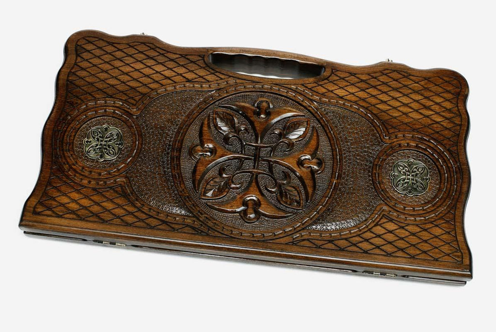 Carved beechwood backgammon board with a central medallion and bronze roundels, propped open