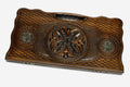 Carved beechwood backgammon board with a central medallion and bronze roundels, propped open