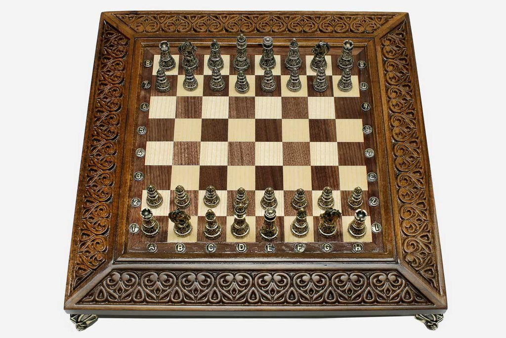Carved chess set shown folded with carry handle