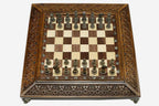 Carved chess set shown folded with carry handle