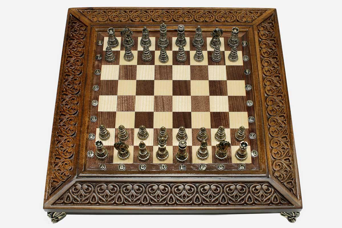Carved chess set shown folded with carry handle