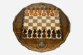 Twelve-sided carved chess board with an inlaid Russian coat-of-arms medallion and turned wooden pieces set up for play