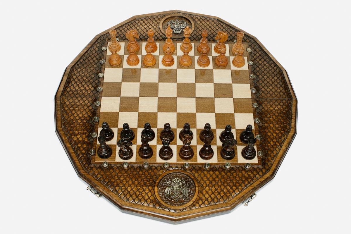 Twelve-sided carved chess board with an inlaid Russian coat-of-arms medallion and turned wooden pieces set up for play