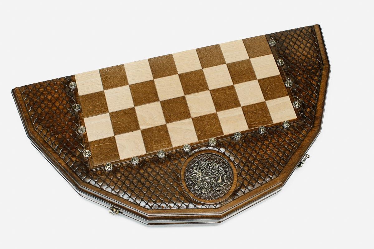 Angled view of the coat-of-arms chess set with its dark and light wooden pieces