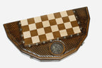 Angled view of the coat-of-arms chess set with its gold and dark bronze pieces