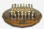 Twelve-sided carved chess board with an inlaid coat-of-arms medallion and ornate bronze figural pieces set up for play