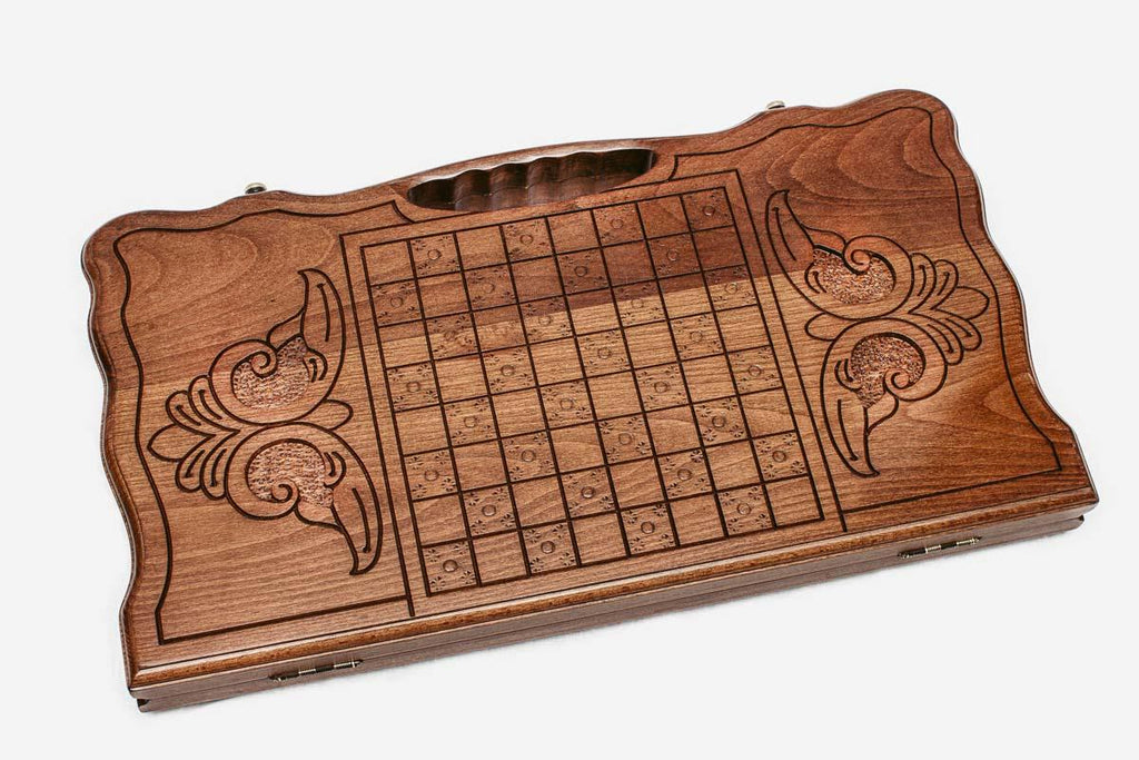 Angled view of the horse medallion carved backgammon board