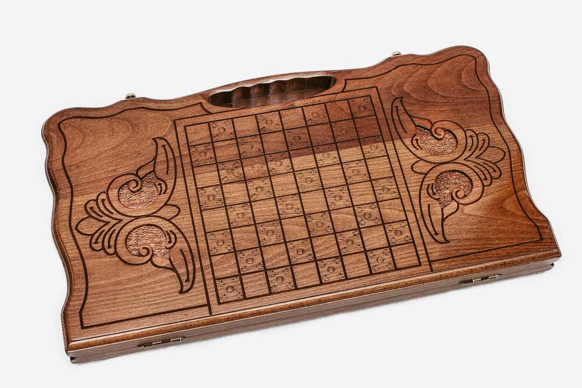 Angled view of the horse medallion carved backgammon board