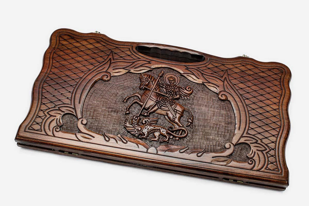 Carved beechwood backgammon board with Saint George slaying the dragon and a carry handle, propped open