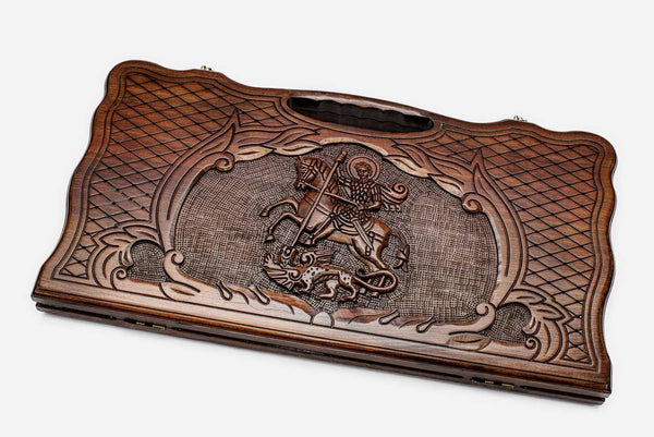 Carved beechwood backgammon board with Saint George slaying the dragon and a carry handle, propped open