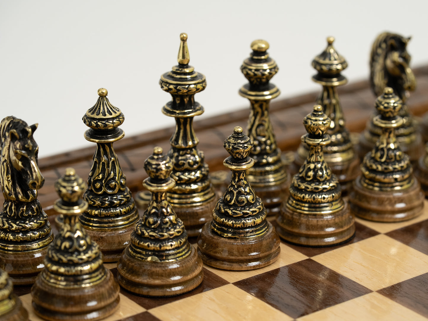 Closed view of a handmade chess set with storage, featuring bronze chess pieces visible inside.