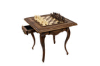 Wooden chess table set up with hand-carved chess pieces
