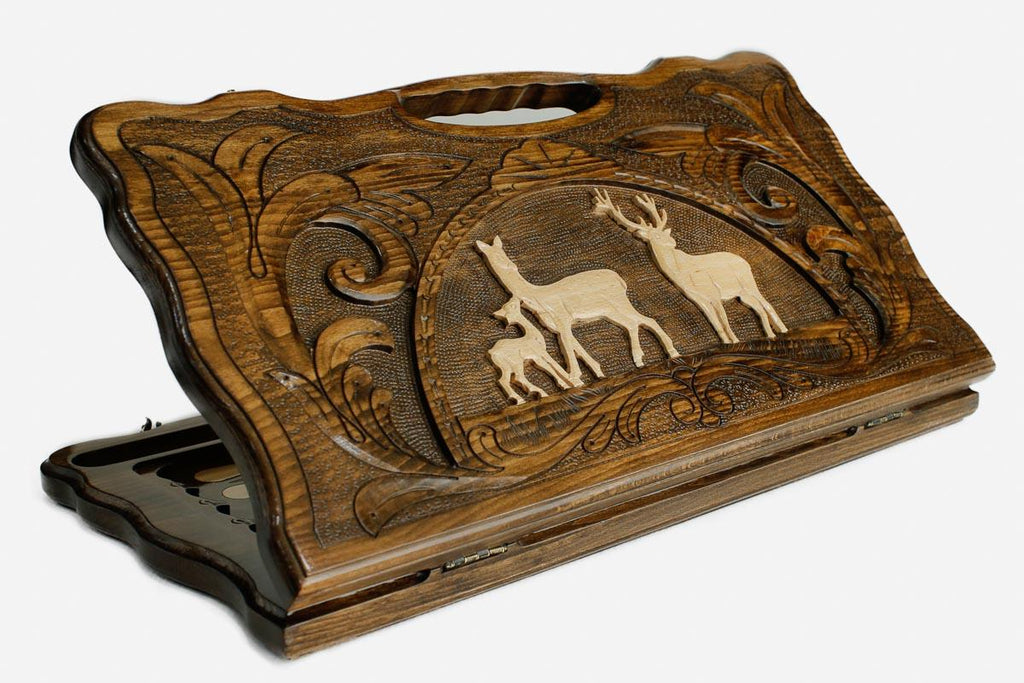 Carved beechwood backgammon board with a pair of deer in a medallion and a carry handle, propped open