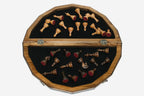 Overhead view of the polygonal board with the full set of light and dark pieces