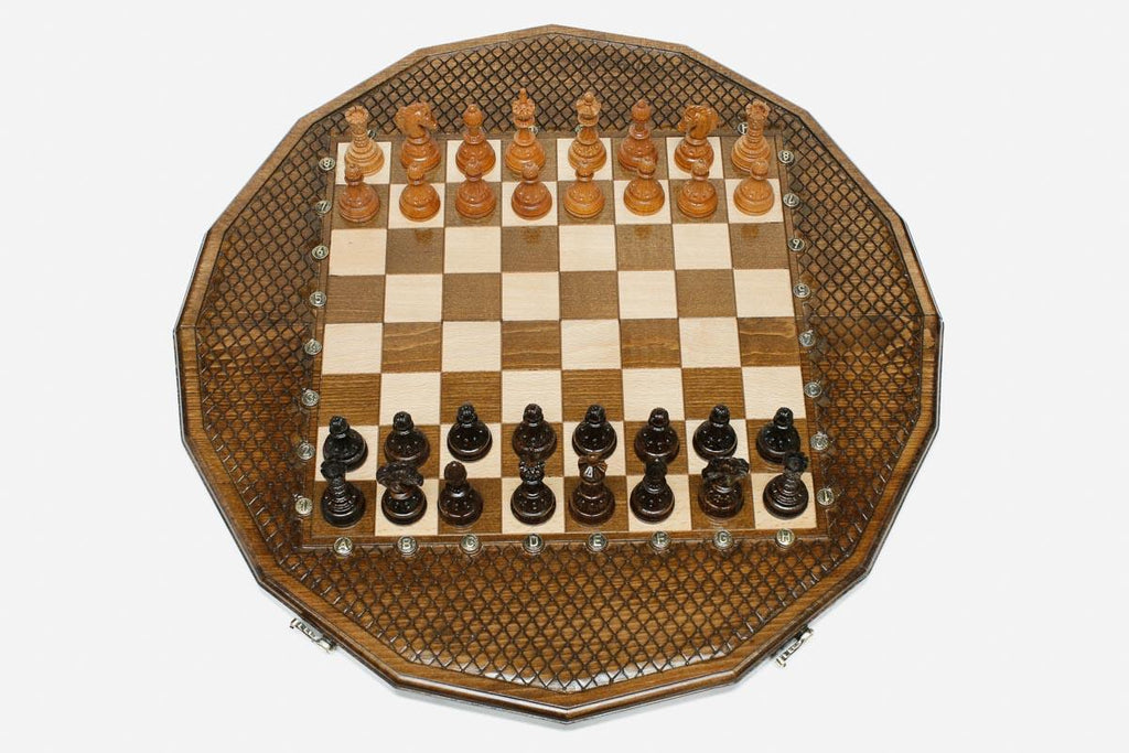 Sixteen-sided carved chess board with a lattice border and beech and walnut pieces set up for play