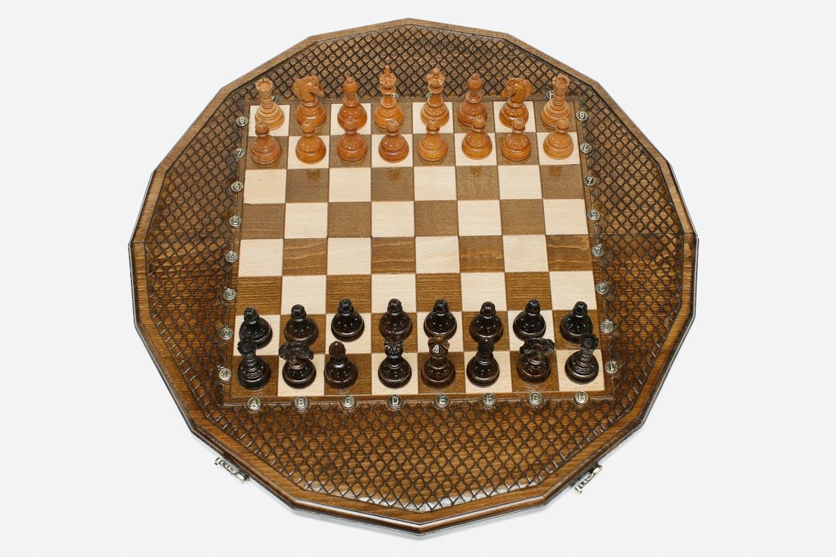 Sixteen-sided carved chess board with a lattice border and beech and walnut pieces set up for play