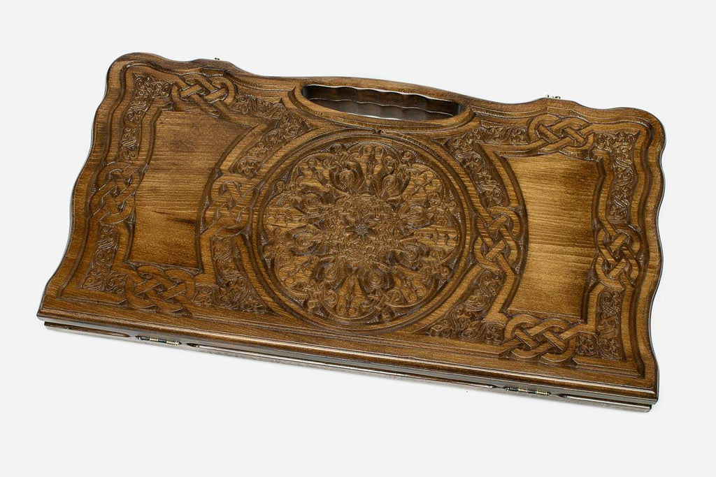 Carved beechwood backgammon board with a grand rosette medallion and knotwork panels, propped open