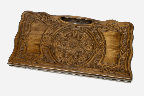 Carved beechwood backgammon board with a grand rosette medallion and knotwork panels, propped open