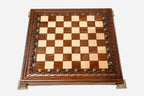 Carved chess set shown folded with carry handle