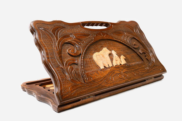 Carved beechwood backgammon board with a bear family medallion and a carry handle, propped open