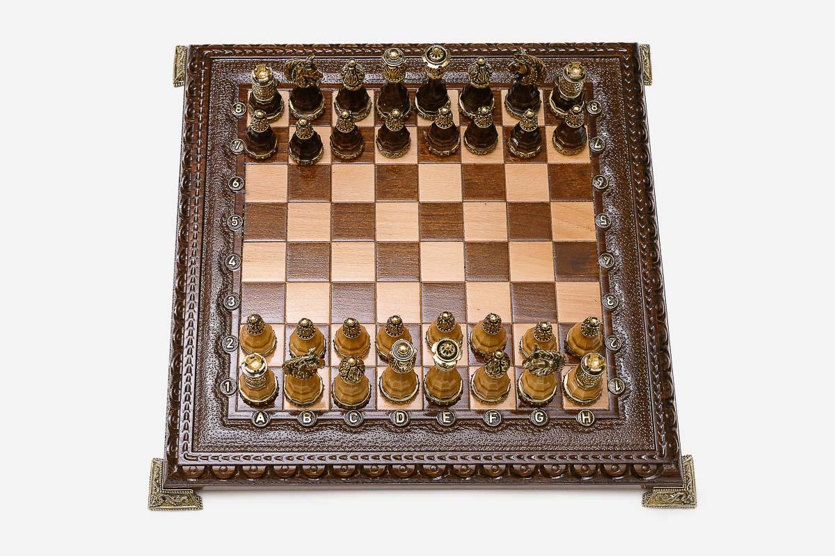Carved chess set shown folded with carry handle