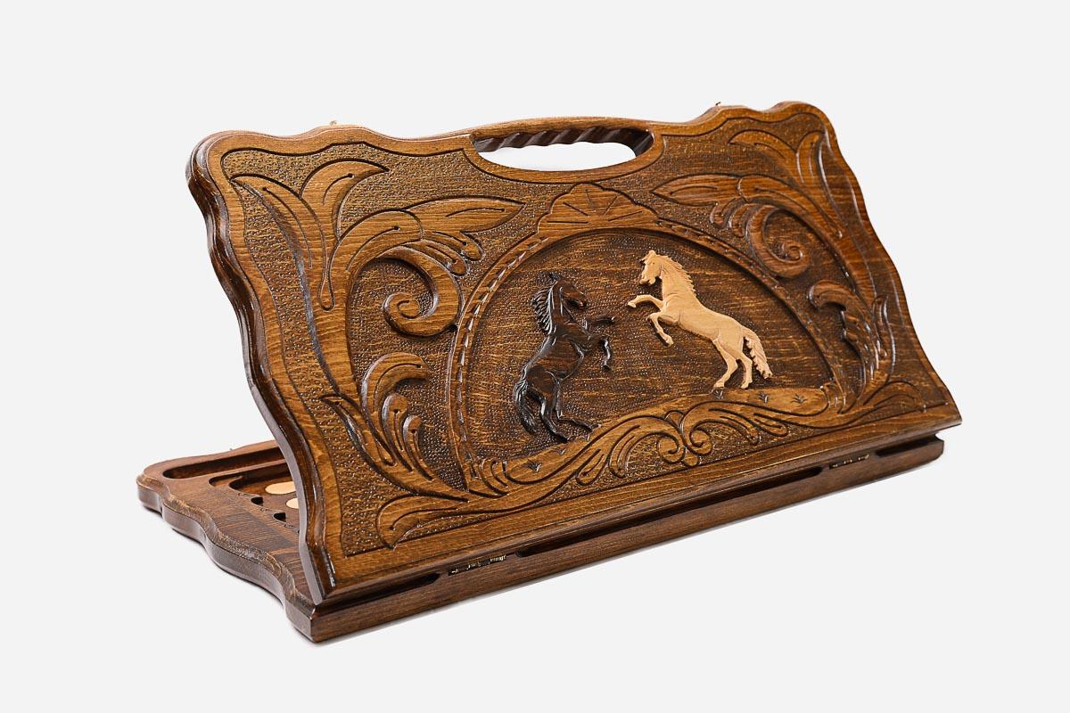 Carved beechwood backgammon board with two rearing horses in a medallion and a carry handle, propped open