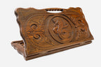 Carved beechwood backgammon board with twin serpents around a floral medallion and a carry handle, propped open