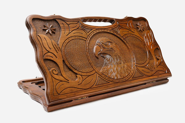 Carved beechwood backgammon board with an eagle medallion and stars, with a carry handle, propped open