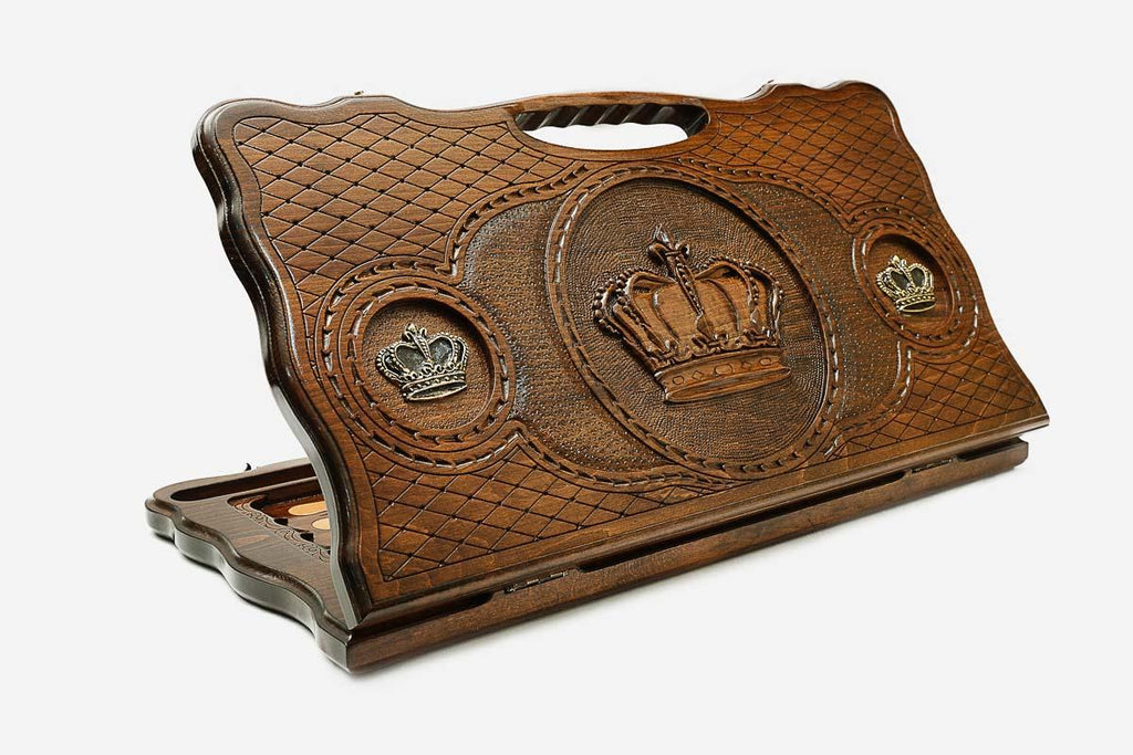 Carved beechwood backgammon board with a crown medallion and bronze accents, with a carry handle, propped open