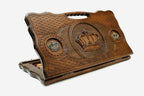 Carved beechwood backgammon board with a crown medallion and bronze accents, with a carry handle, propped open