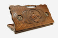 Carved beechwood backgammon board with a scorpion medallion and bronze accents, with a carry handle, propped open