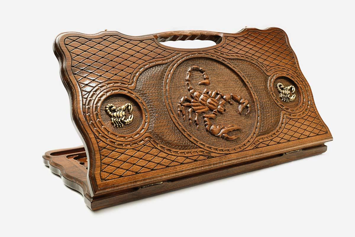 Carved beechwood backgammon board with a scorpion medallion and bronze accents, with a carry handle, propped open